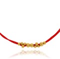 bransoletka stal pozłacane kulki jedwabna nić kolor czerwony
